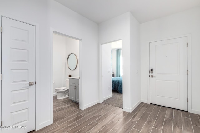 entrance foyer featuring wood finished floors and baseboards