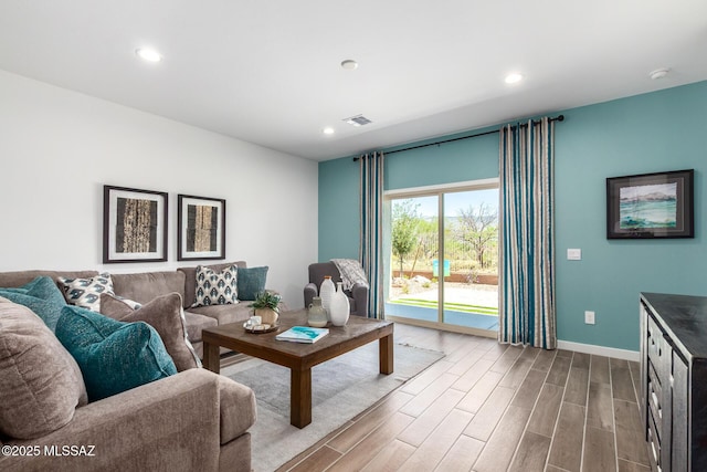 living area with recessed lighting, visible vents, wood finished floors, and baseboards