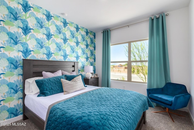 carpeted bedroom featuring baseboards and wallpapered walls
