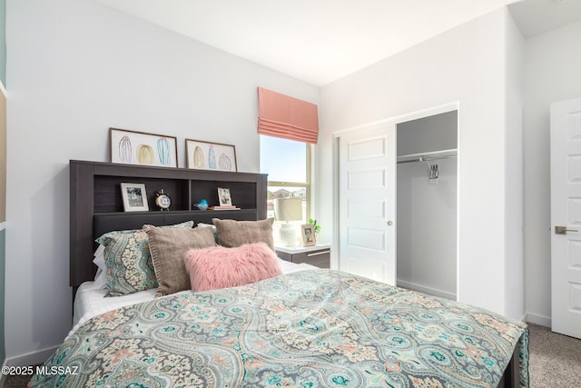 carpeted bedroom with baseboards and a closet