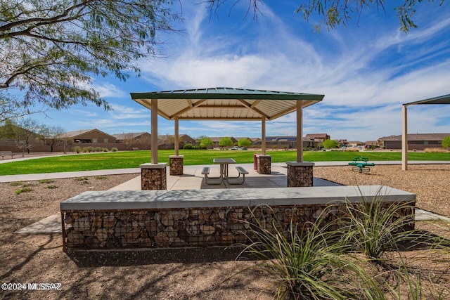 view of property's community featuring a lawn and a gazebo