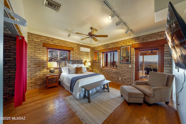 221 Calle Coco, Nogales, AZ 85621 - bedroom with track lighting, brick wall, and multiple windows