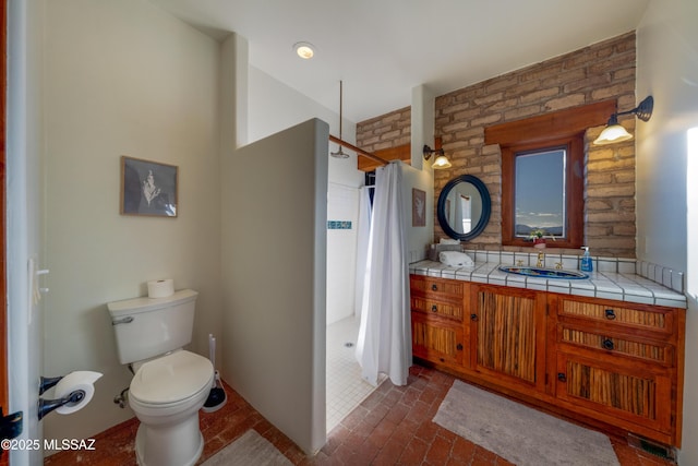 221 Calle Coco, Nogales, AZ 85621 - bathroom featuring toilet, brick floor, a tile shower, and vanity