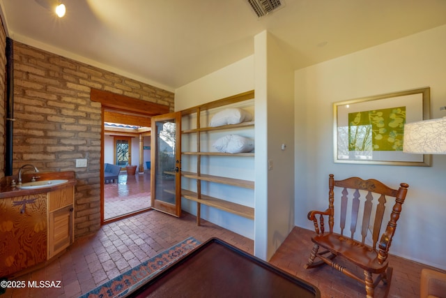 221 Calle Coco, Nogales, AZ 85621 - bathroom featuring visible vents, brick floor, french doors, and vanity
