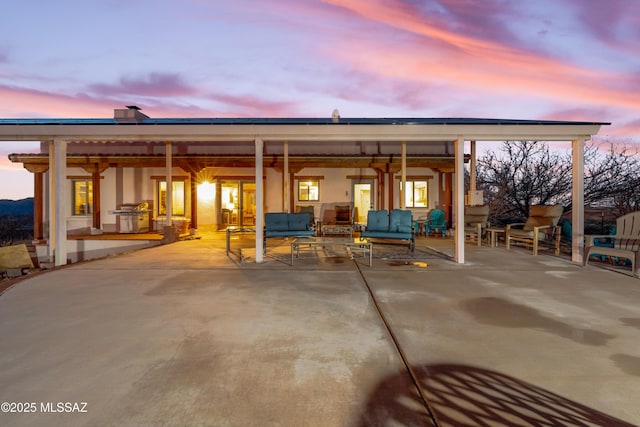 221 Calle Coco, Nogales, AZ 85621 - patio terrace at dusk with an outdoor hangout area and a grill