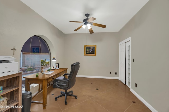 tiled home office with baseboards and a ceiling fan
