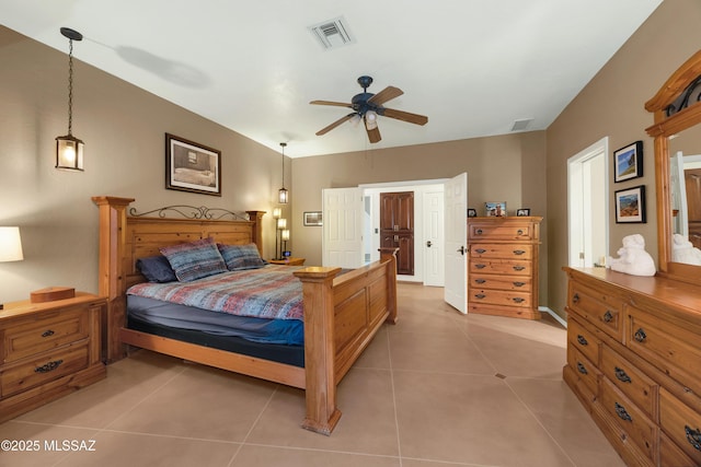 bedroom with a ceiling fan, visible vents, and light tile patterned floors