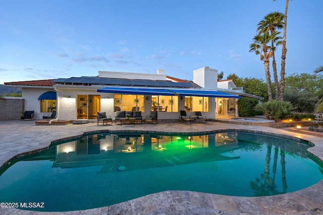 outdoor pool with a patio and outdoor lounge area