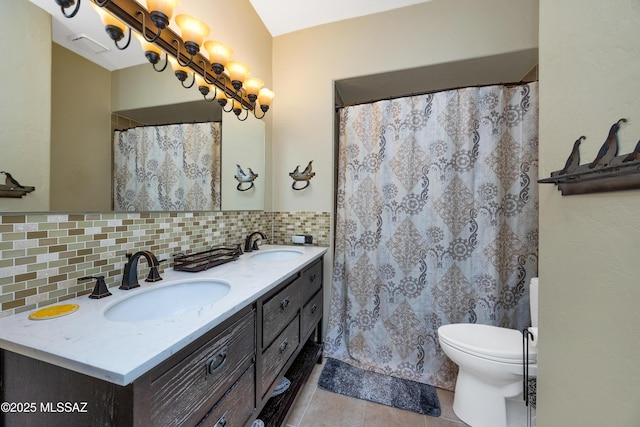 full bath featuring a sink, tile patterned flooring, decorative backsplash, and double vanity