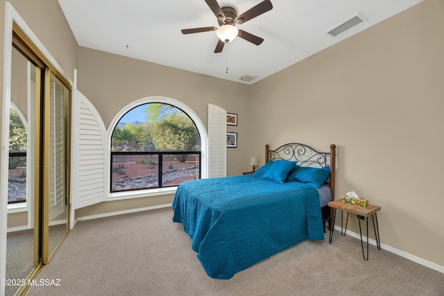 bedroom with carpet floors, baseboards, ceiling fan, and visible vents