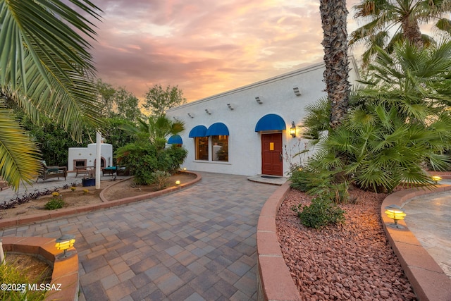 exterior space featuring a patio and stucco siding