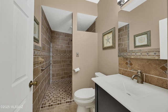 bathroom with vanity, a walk in shower, and toilet