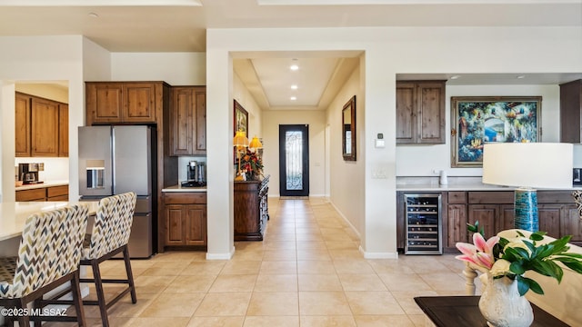 2230 E Thunder Bluff Dr, Green Valley, AZ 85614 - kitchen with beverage cooler, stainless steel fridge, light tile patterned floors, light countertops, and recessed lighting