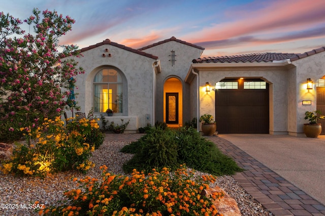 2230 E Thunder Bluff Dr, Green Valley, AZ 85614 - mediterranean / spanish home with driveway, a garage, a tiled roof, and stucco siding