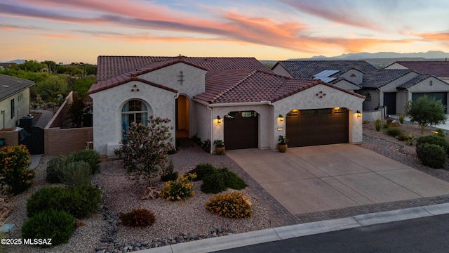 2230 E Thunder Bluff Dr, Green Valley, AZ 85614 - mediterranean / spanish-style house featuring an attached garage, stucco siding, driveway, and a tile roof