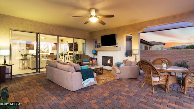2230 E Thunder Bluff Dr, Green Valley, AZ 85614 - living area featuring a ceiling fan and a lit fireplace