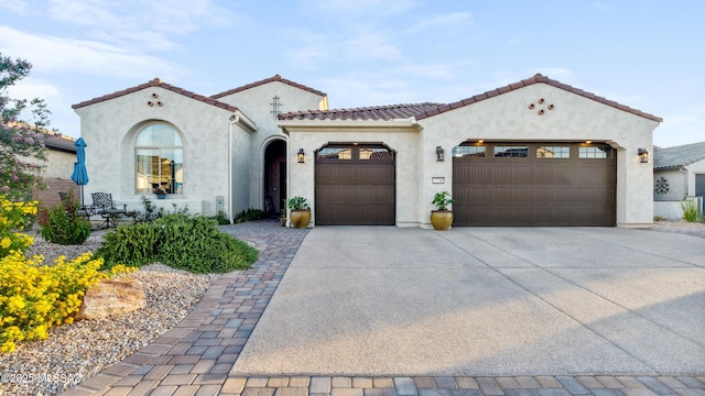 2230 E Thunder Bluff Dr, Green Valley, AZ 85614 - mediterranean / spanish-style house featuring an attached garage, stucco siding, driveway, and a tile roof
