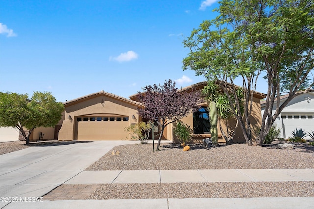 4706 W Cholla Bluff Dr, Marana, AZ 85658 - view of front of home with stucco siding, concrete driveway, an attached garage, and a tiled roof