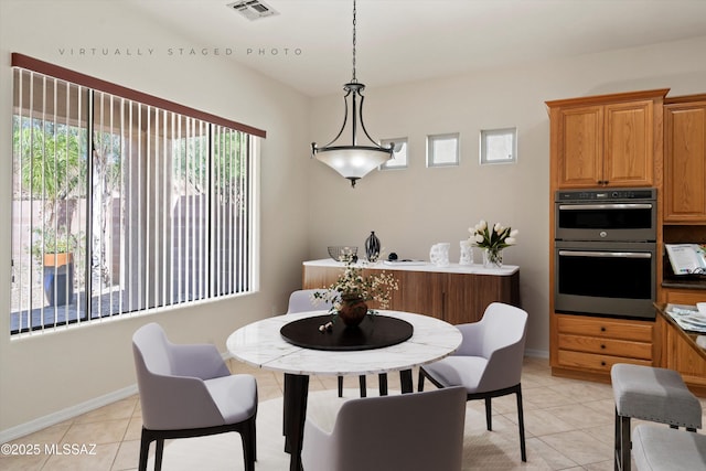 4706 W Cholla Bluff Dr, Marana, AZ 85658 - dining area featuring light tile patterned floors and baseboards