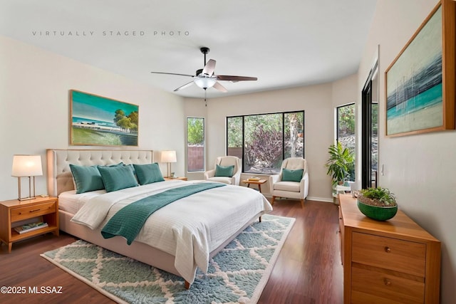 4706 W Cholla Bluff Dr, Marana, AZ 85658 - bedroom with dark wood finished floors, baseboards, and ceiling fan