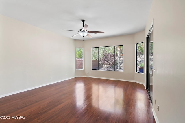 4706 W Cholla Bluff Dr, Marana, AZ 85658 - unfurnished room with a ceiling fan, dark wood-style floors, and baseboards