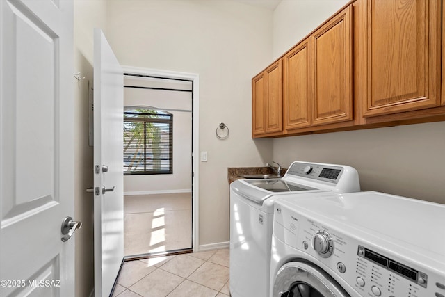 4706 W Cholla Bluff Dr, Marana, AZ 85658 - laundry area featuring independent washer and dryer, cabinet space, light tile patterned floors, and baseboards