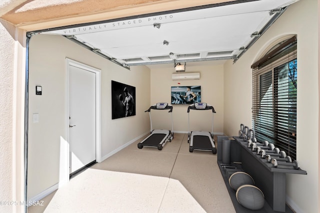 4706 W Cholla Bluff Dr, Marana, AZ 85658 - workout area featuring a garage, baseboards, and a wall unit AC