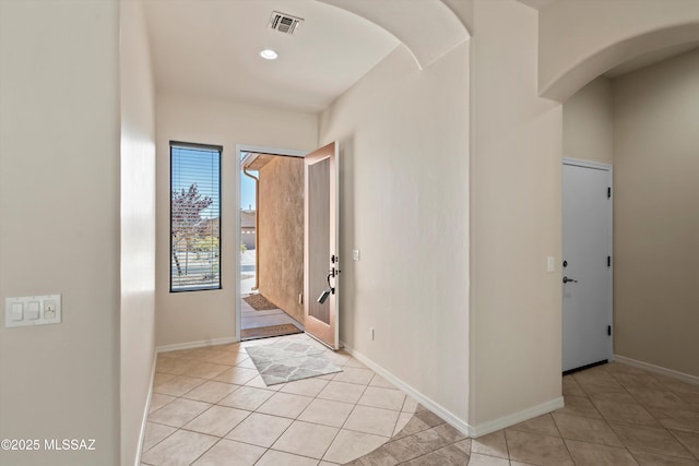 4706 W Cholla Bluff Dr, Marana, AZ 85658 - entryway featuring light tile patterned floors, arched walkways, and baseboards
