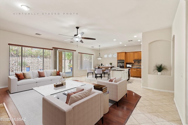4706 W Cholla Bluff Dr, Marana, AZ 85658 - living room with baseboards, ceiling fan, light tile patterned floors, and recessed lighting
