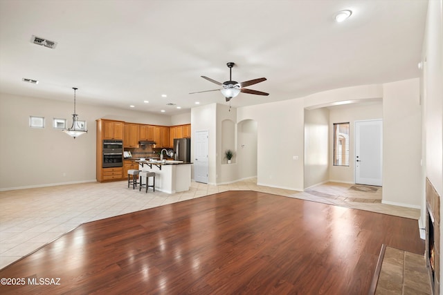 4706 W Cholla Bluff Dr, Marana, AZ 85658 - unfurnished living room featuring arched walkways, ceiling fan, recessed lighting, baseboards, and light tile patterned flooring
