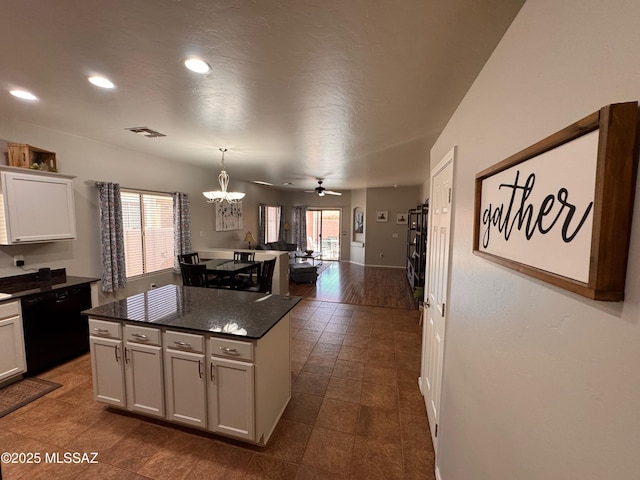kitchen with recessed lighting, black dishwasher, a center island, visible vents, and dark countertops