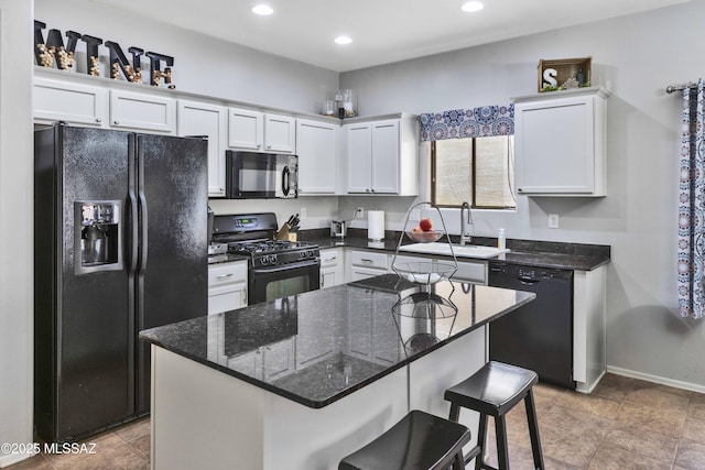 14472 S Camino Tierra Monte, Sahuarita, AZ 85629 - kitchen with black appliances, a sink, white cabinetry, a breakfast bar, and recessed lighting