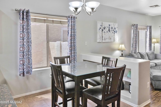 14472 S Camino Tierra Monte, Sahuarita, AZ 85629 - dining room featuring a chandelier, baseboards, and tile patterned floors