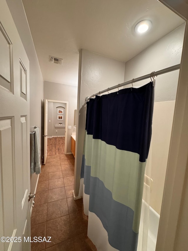 bathroom with tile patterned flooring, visible vents, vanity, and a shower with shower curtain
