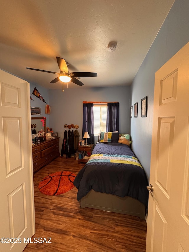 bedroom with ceiling fan and wood finished floors