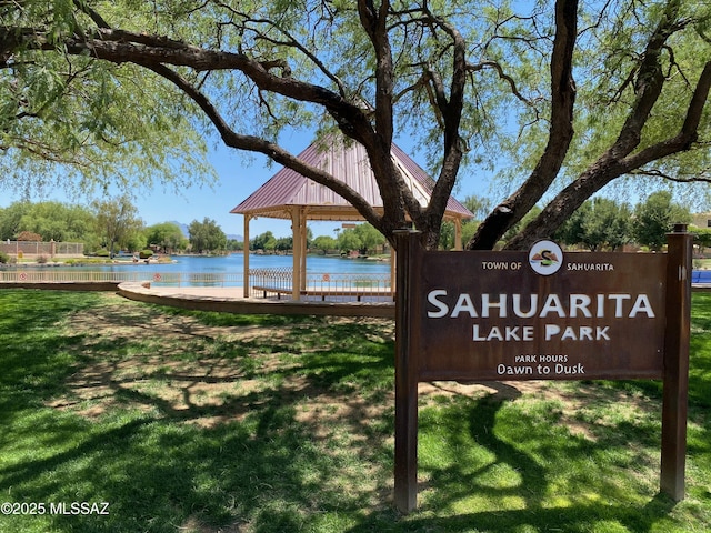 view of community with a yard and a water view
