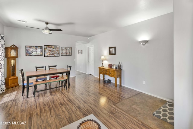 14472 S Camino Tierra Monte, Sahuarita, AZ 85629 - dining space featuring a ceiling fan, arched walkways, wood finished floors, and baseboards