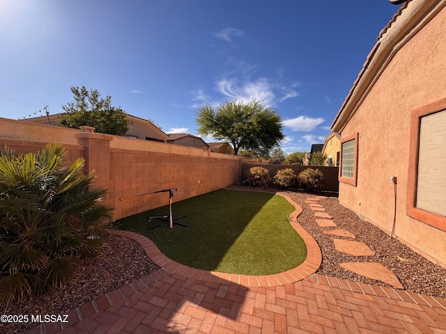 view of yard featuring a patio and a fenced backyard