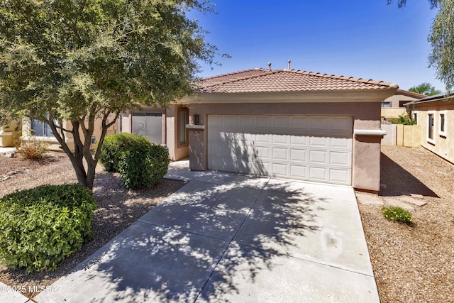 14472 S Camino Tierra Monte, Sahuarita, AZ 85629 - view of front facade featuring stucco siding, concrete driveway, an attached garage, and a tiled roof