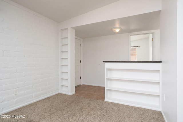 5930 E 32nd St, Tucson, AZ 85711 - carpeted empty room featuring baseboards and tile patterned flooring