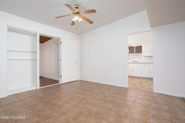 5930 E 32nd St, Tucson, AZ 85711 - unfurnished bedroom with a sink, light tile patterned flooring, ceiling fan, baseboards, and lofted ceiling