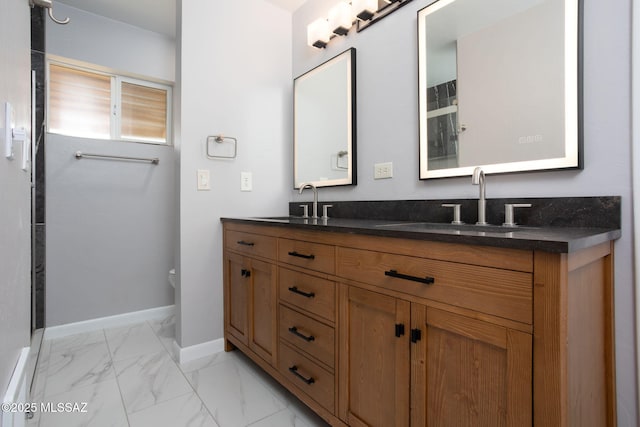 5930 E 32nd St, Tucson, AZ 85711 - bathroom with double vanity, baseboards, marble finish floor, and a sink