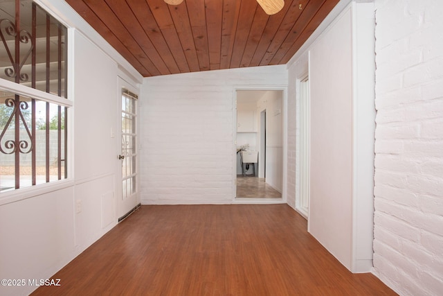 5930 E 32nd St, Tucson, AZ 85711 - hallway featuring wood ceiling, wood finished floors, and brick wall
