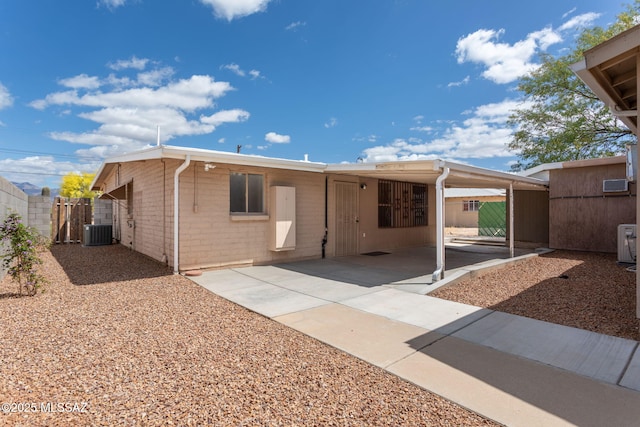 5930 E 32nd St, Tucson, AZ 85711 - view of front of property with fence, cooling unit, and an attached carport