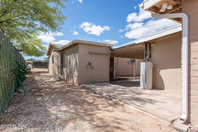 5930 E 32nd St, Tucson, AZ 85711 - exterior space with water heater and fence
