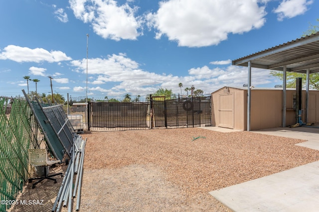 5930 E 32nd St, Tucson, AZ 85711 - view of yard featuring fence, a storage shed, a gate, and an outbuilding