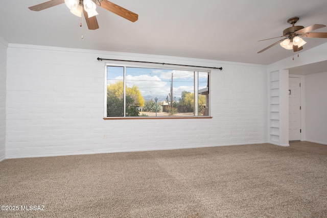5930 E 32nd St, Tucson, AZ 85711 - carpeted empty room featuring built in shelves, a ceiling fan, and brick wall