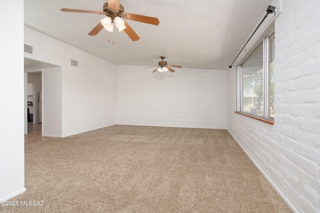 5930 E 32nd St, Tucson, AZ 85711 - carpeted spare room with baseboards, visible vents, a ceiling fan, and brick wall