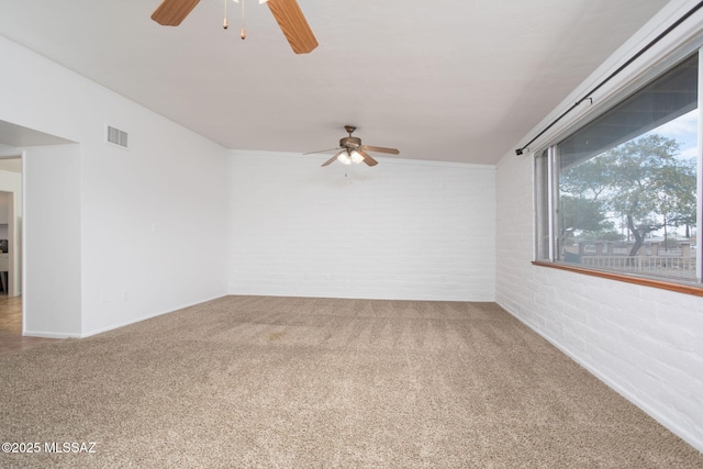 5930 E 32nd St, Tucson, AZ 85711 - carpeted spare room featuring baseboards, visible vents, ceiling fan, and brick wall