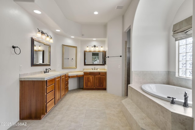 full bath with visible vents, double vanity, recessed lighting, a bath, and a sink